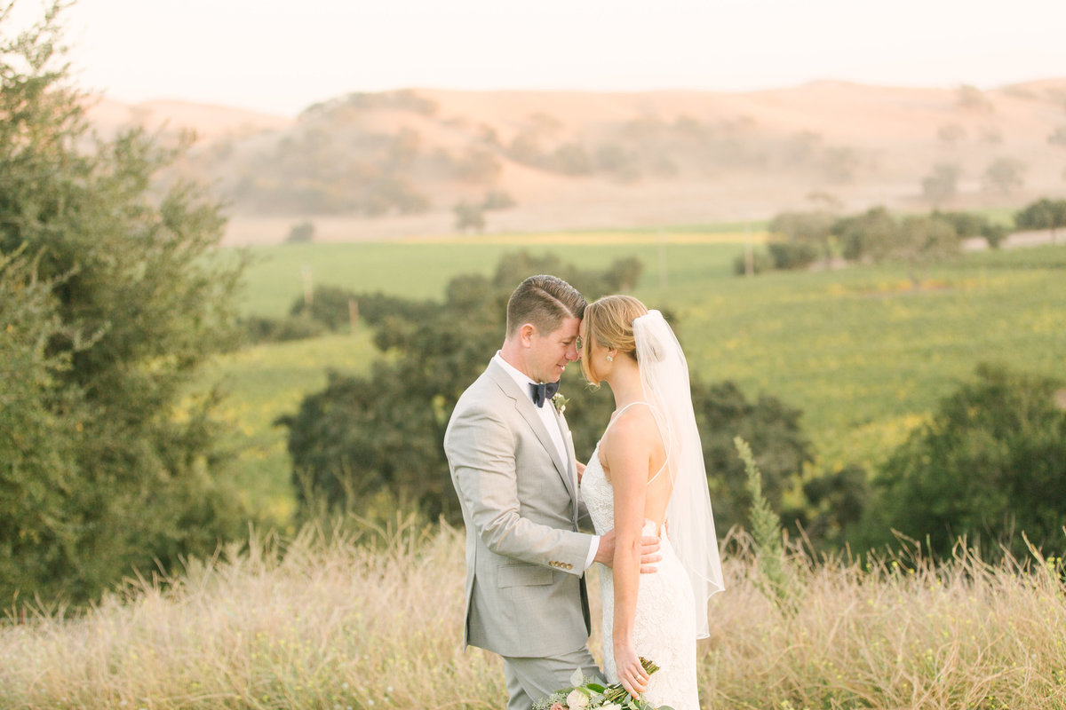 Bride and groom embrace after ceremony at Firestone Vineyard