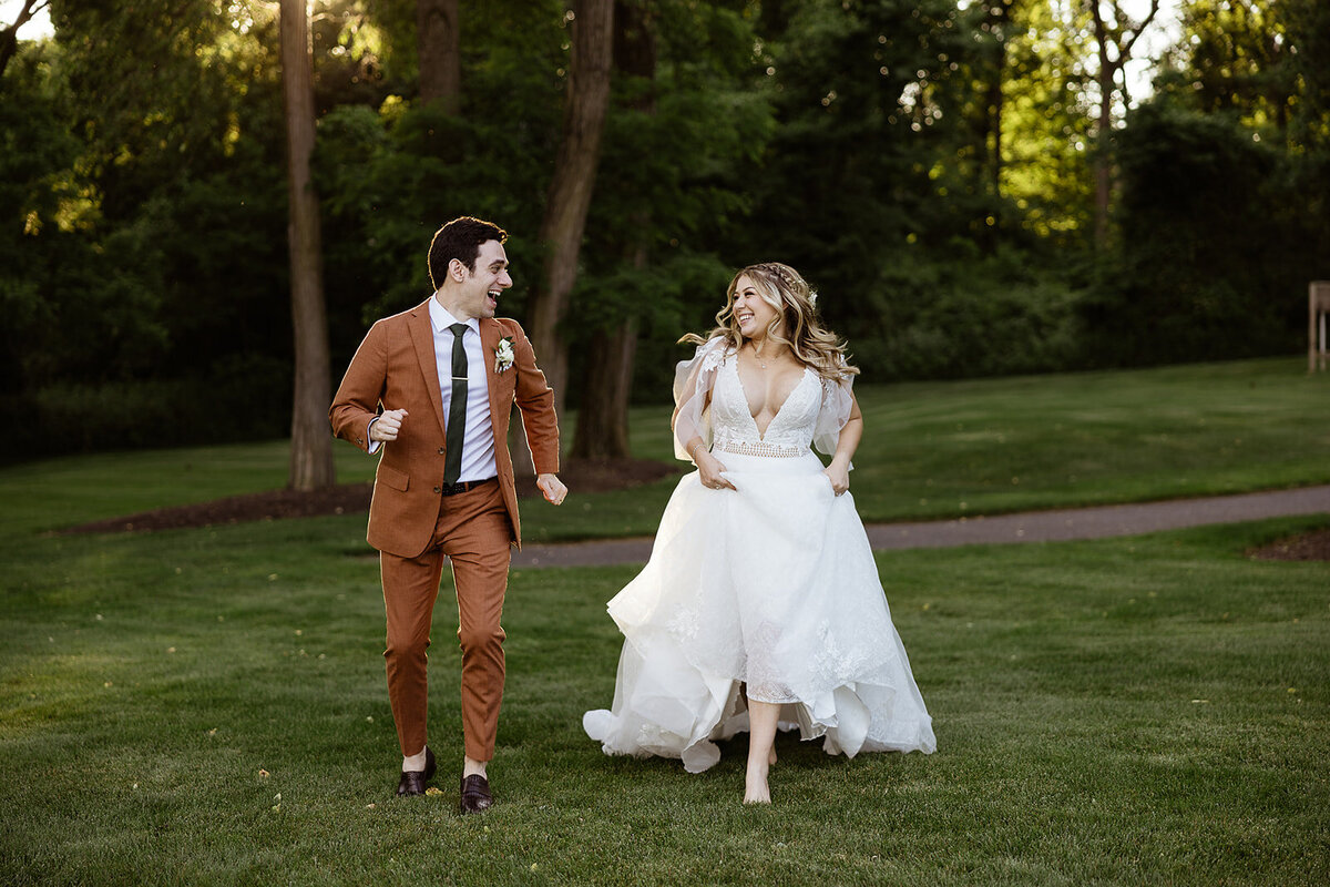 bride and groom run towards camera after destination wedding celebration