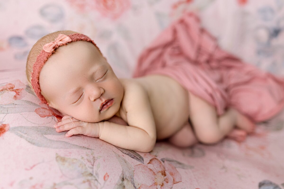 Newborn girl on pink floral backdrop Harrisonburg, VA