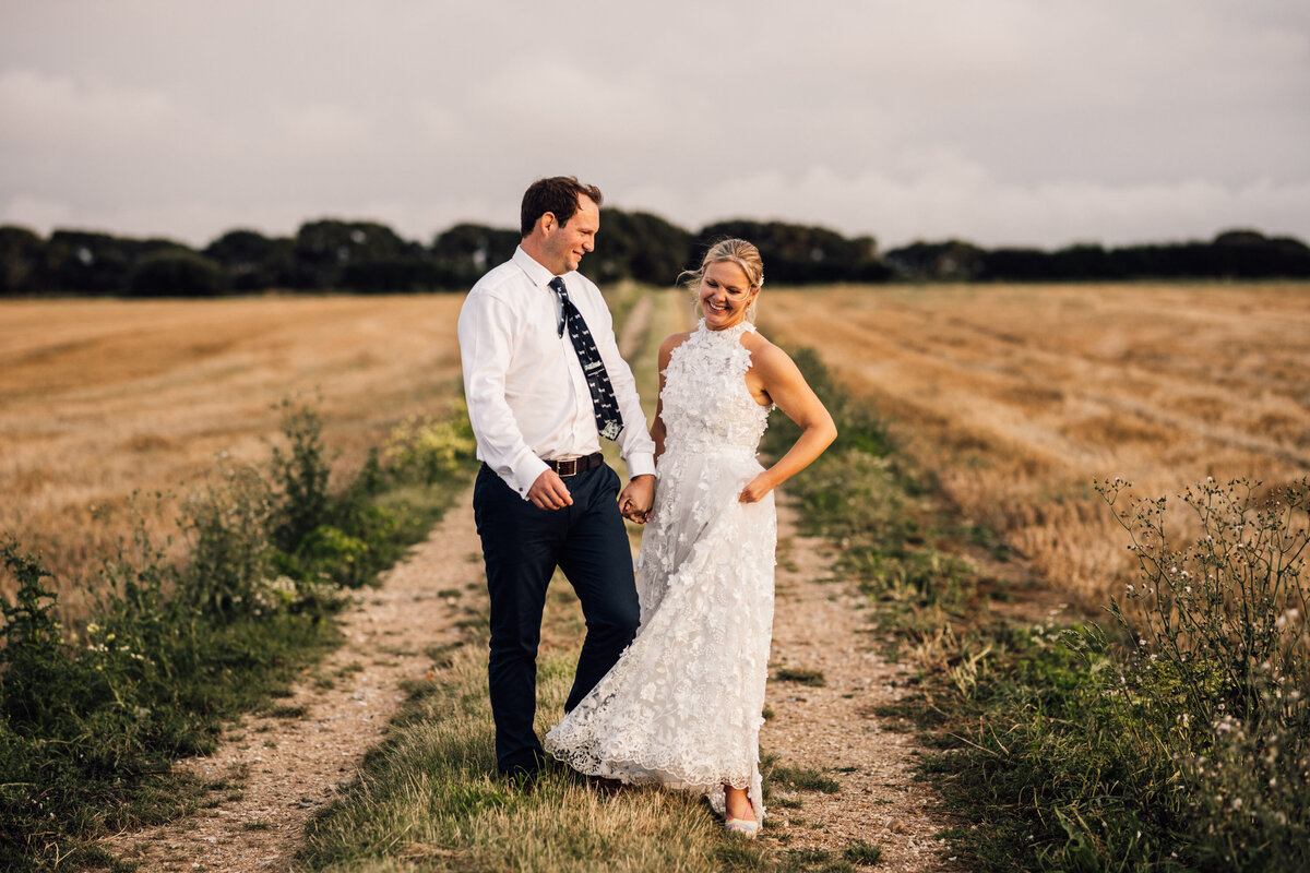 Bride and groom smiling during wedding portraits in Surrey
