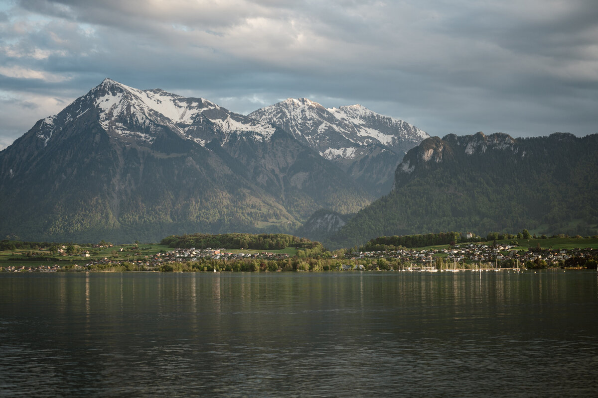 A lake with snow capped mountains in the distance