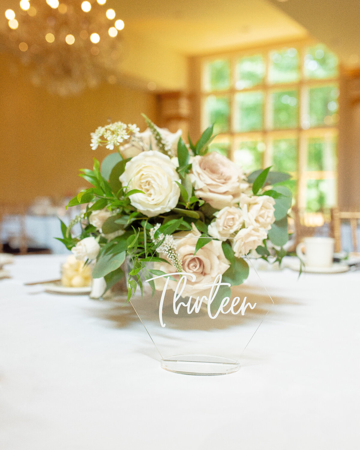 Floral centerpiece and clear table number.