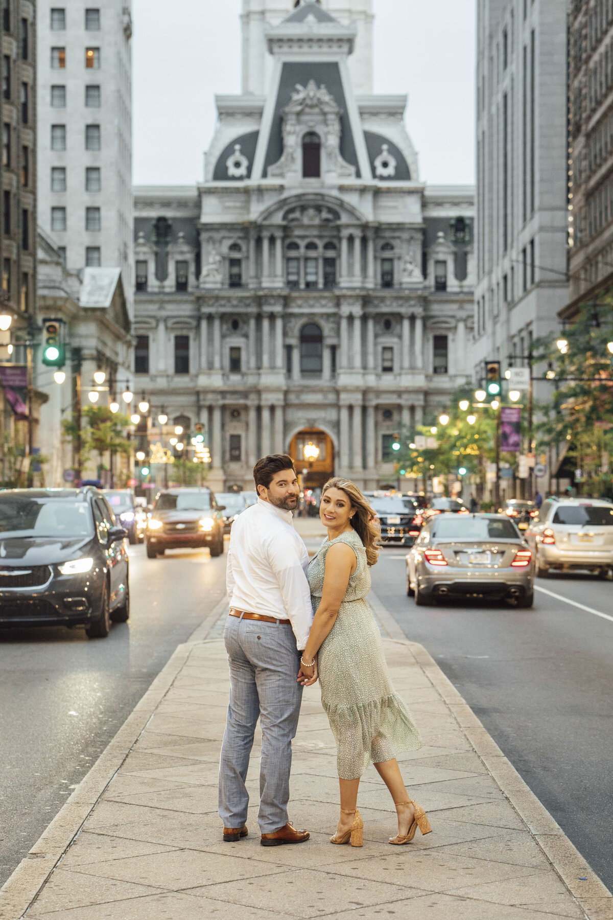 Couple posing during summer engagement photo near Capitol building in Philadelphia Pennsylvania