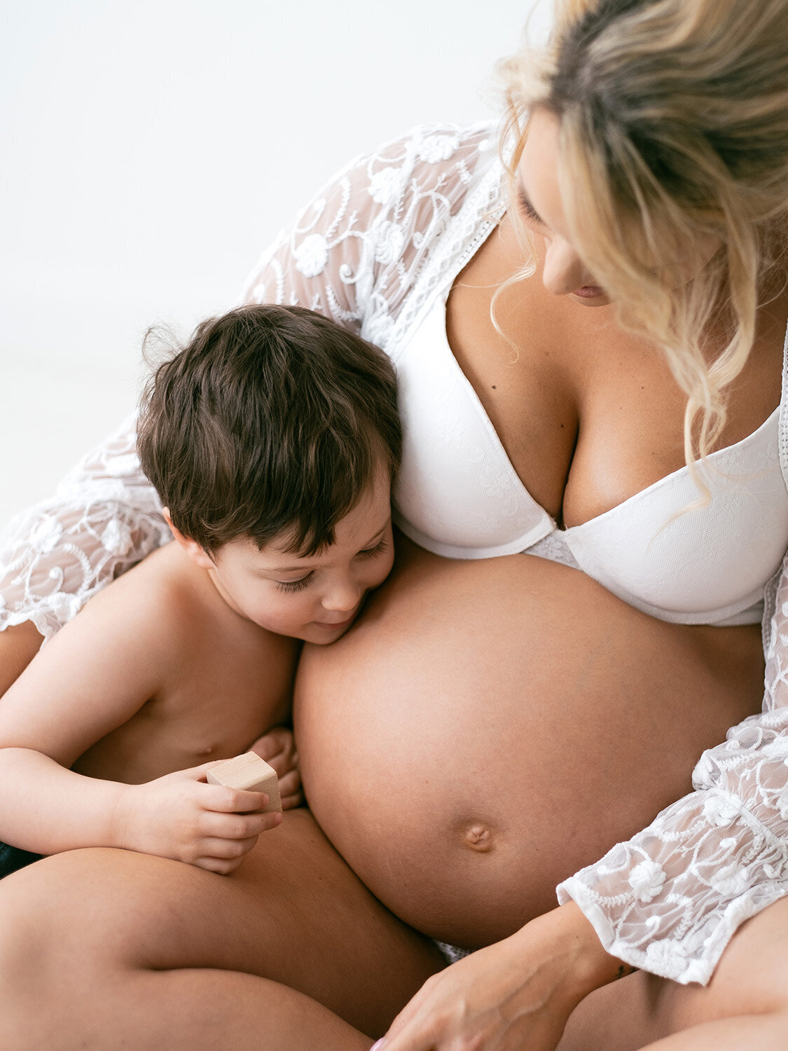 family maternity photoshoot with pregnant mother and yound child