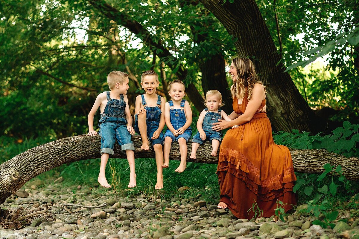 Mom and 4 sons sitting on a tree taken by Be Thou My Vision Photography