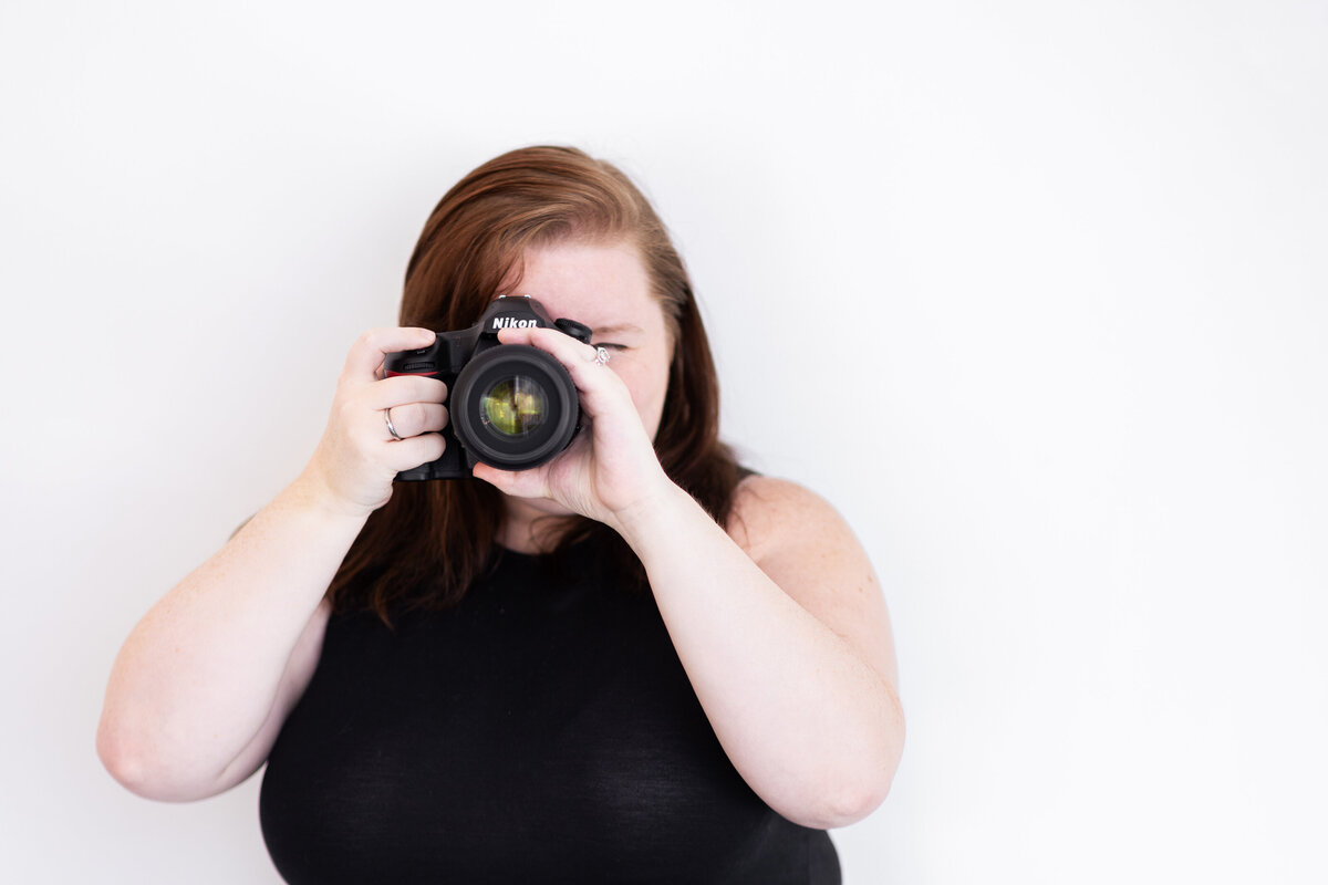 Melissa Cook, Northern VA Wedding Photographer, poses with her camera
