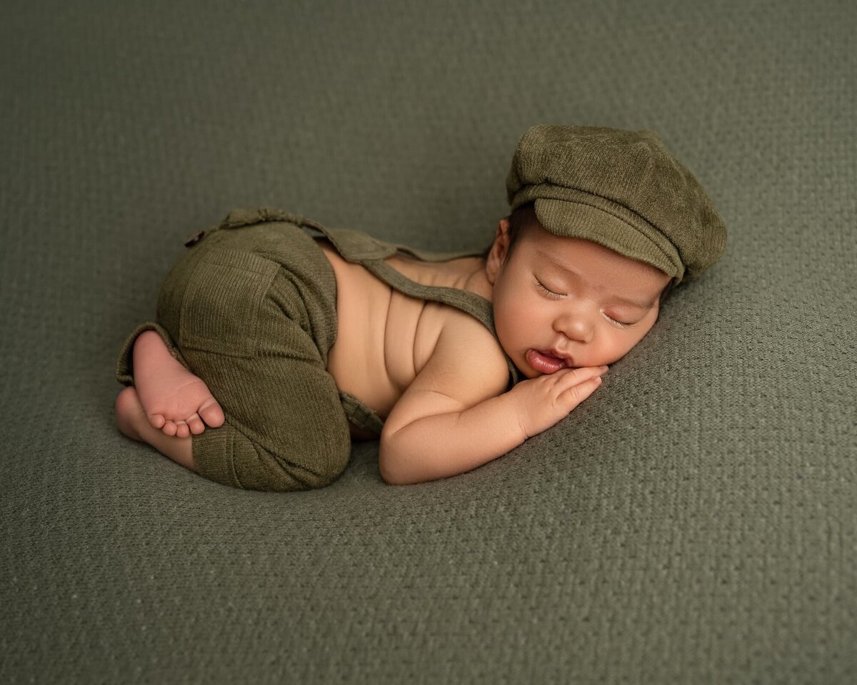 newborn-boy-bum-up-pose-overalls