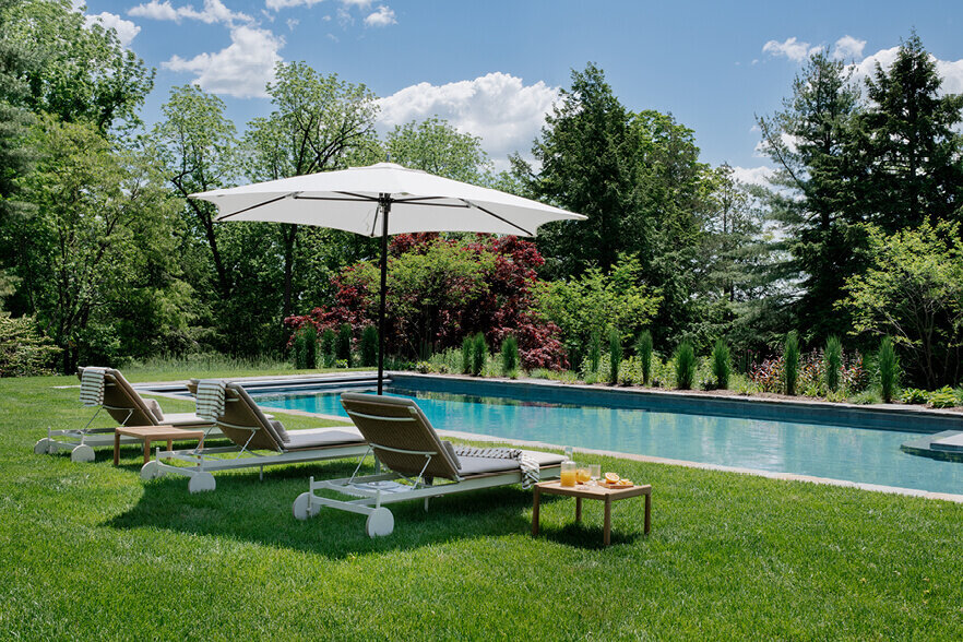 Outdoor furniture selected by an interior decorator in Boston brings modern style and comfort to a historic home’s outdoor living space.