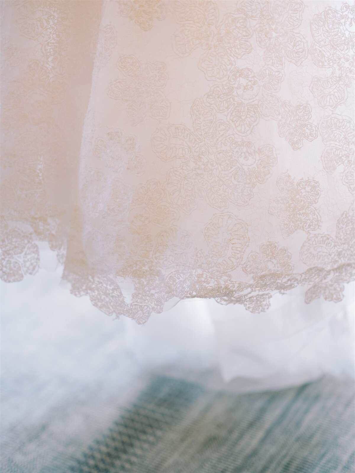 Up close picture of the brides lace gown. 
