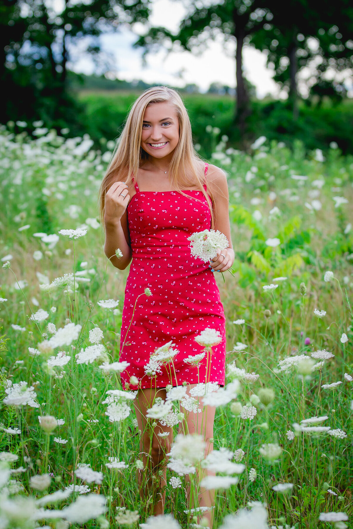Senior picture of a blond girl in a field of wildflowers