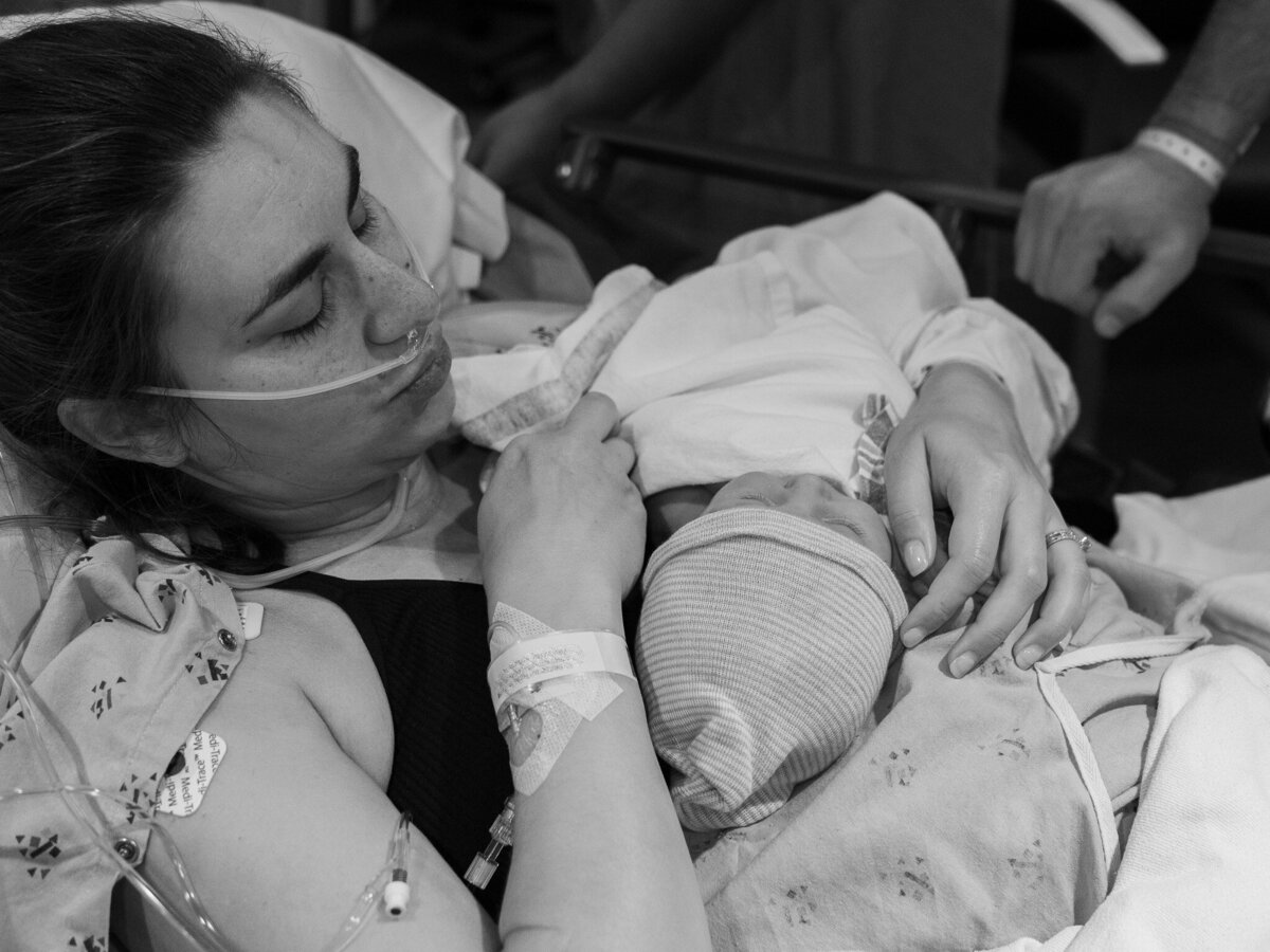 A new mother is holding her baby for the first time after going through a c-section birth at EvergreenHealth Family Maternity Center in Kirkland, WA.