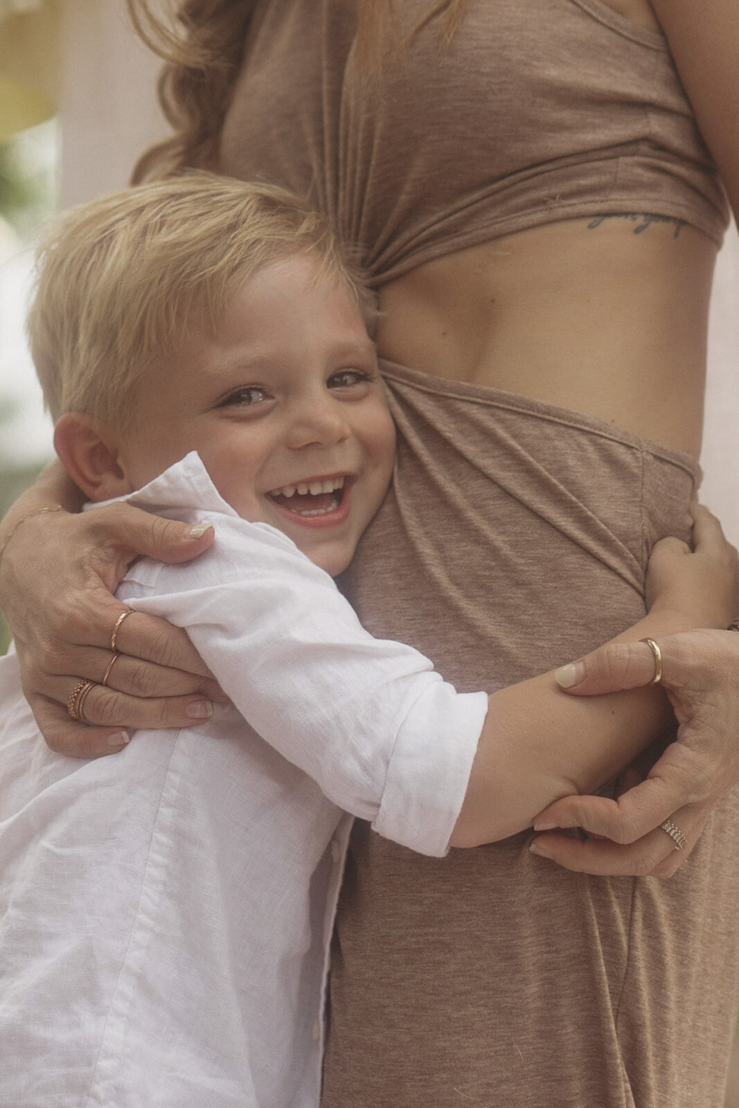 Little boy hugging mother and smiling