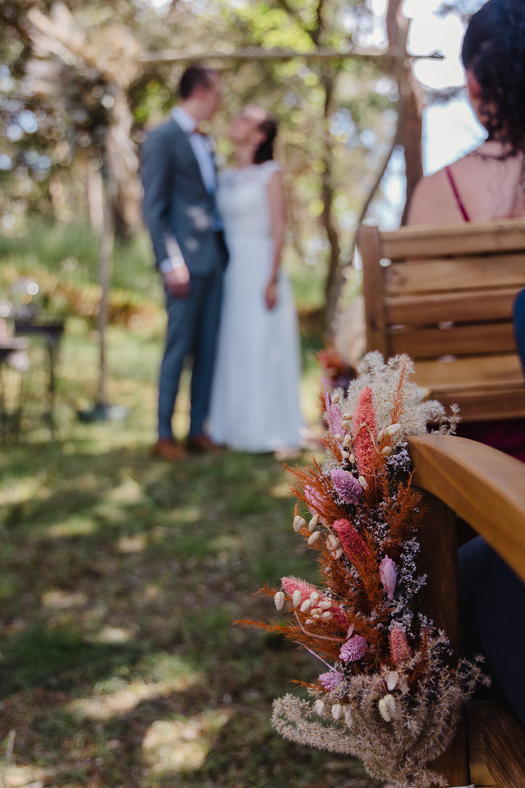 A touching flower detail at the seating arrangement during a forest wedding ceremony, an option in our microwedding package abroad.