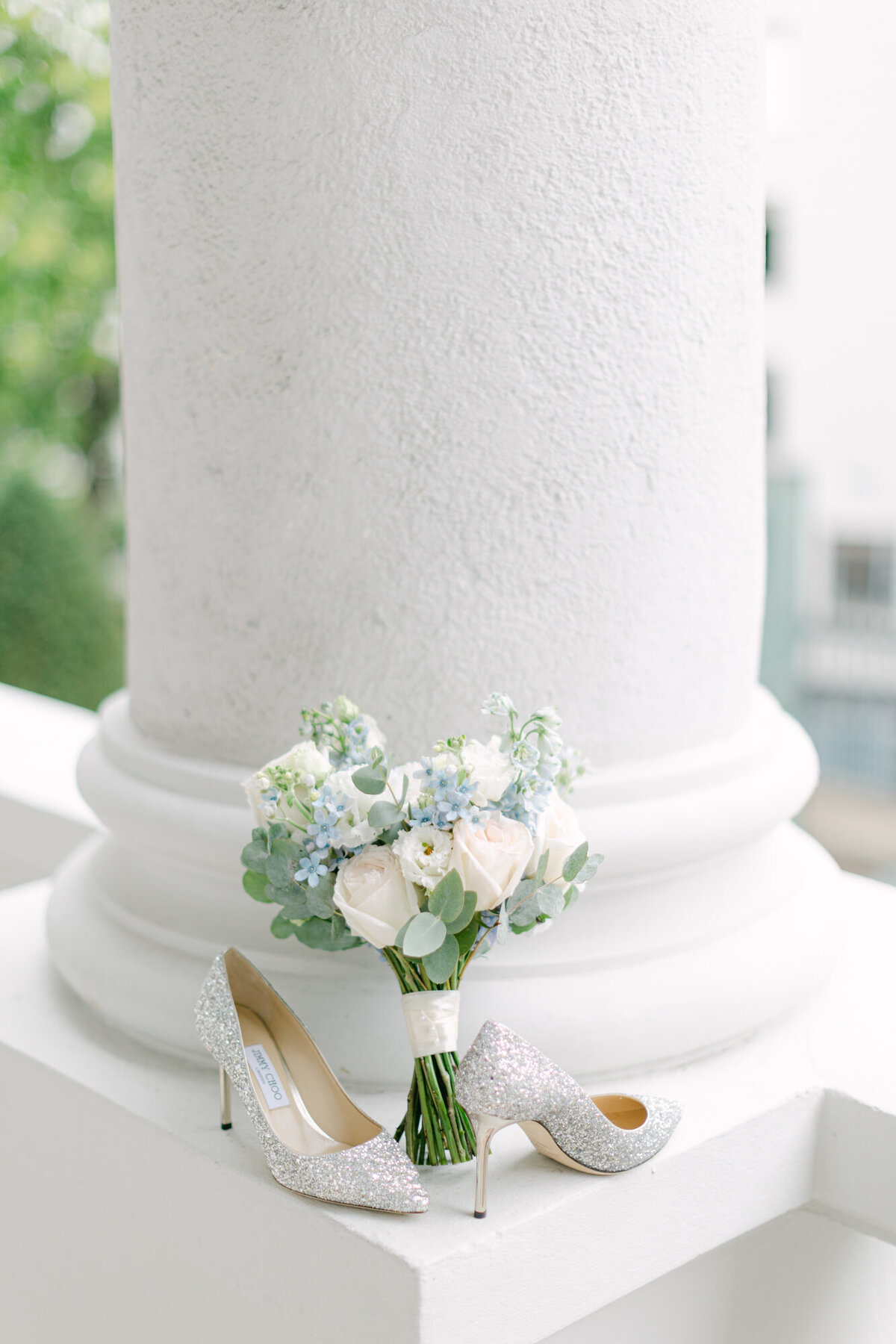 Jimmy Choo wedding shoes and bridal bouquet on the terrace of palace Coburg in Vienna