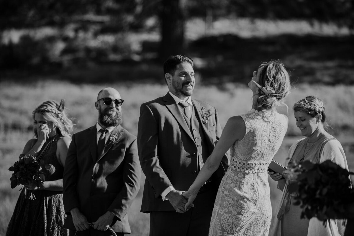 Two marriers laugh during their wedding ceremony.