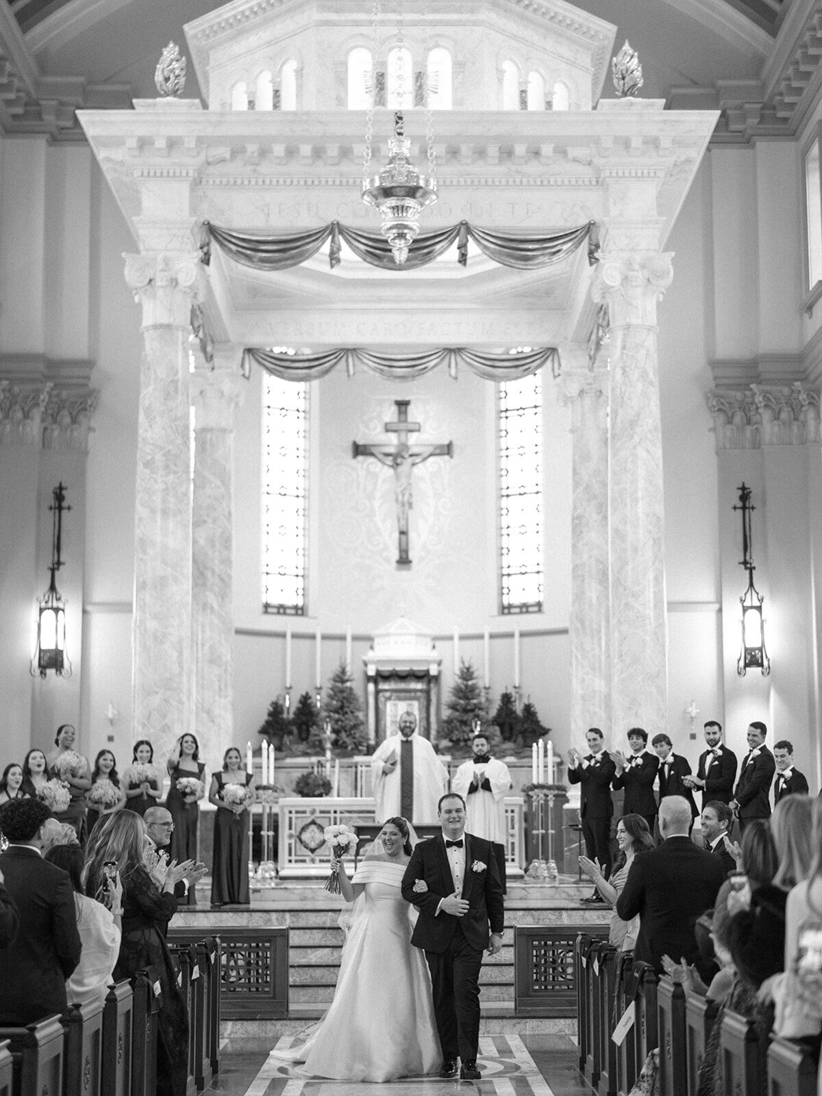 Black and white image of a wedding ceremony at Cathedral of the Most Sacred Heart of Jesus in Tennessee