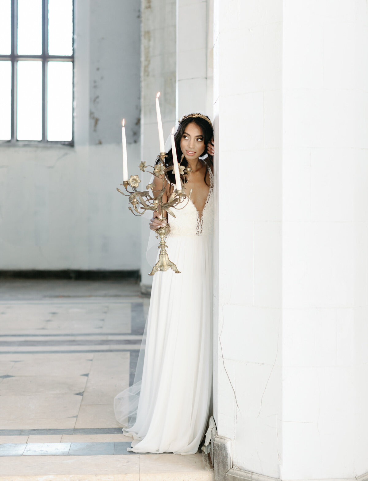 bride with candelabra in beautiful ruins wedding venue in Italy