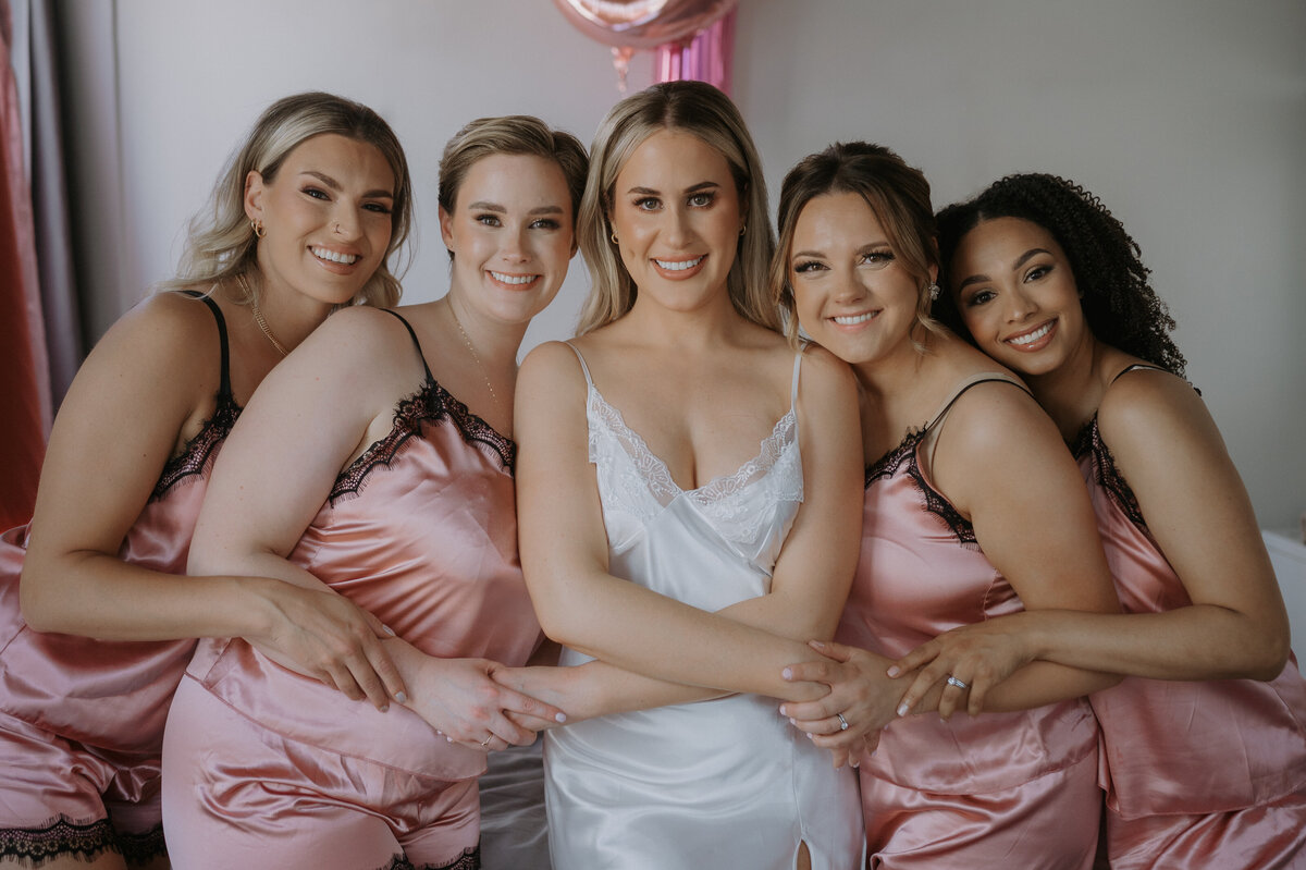 bride and bridesmaids getting reading for edmonton wedding 