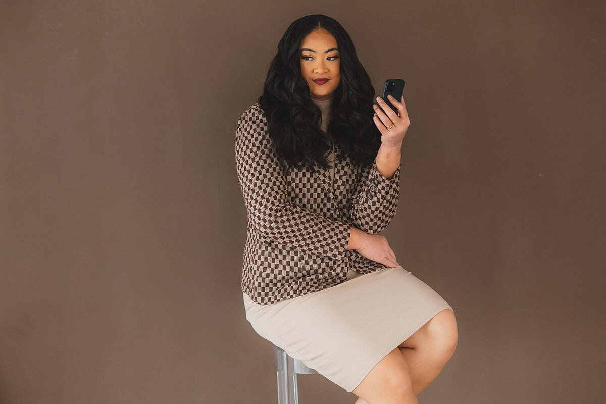 A woman holds her phone