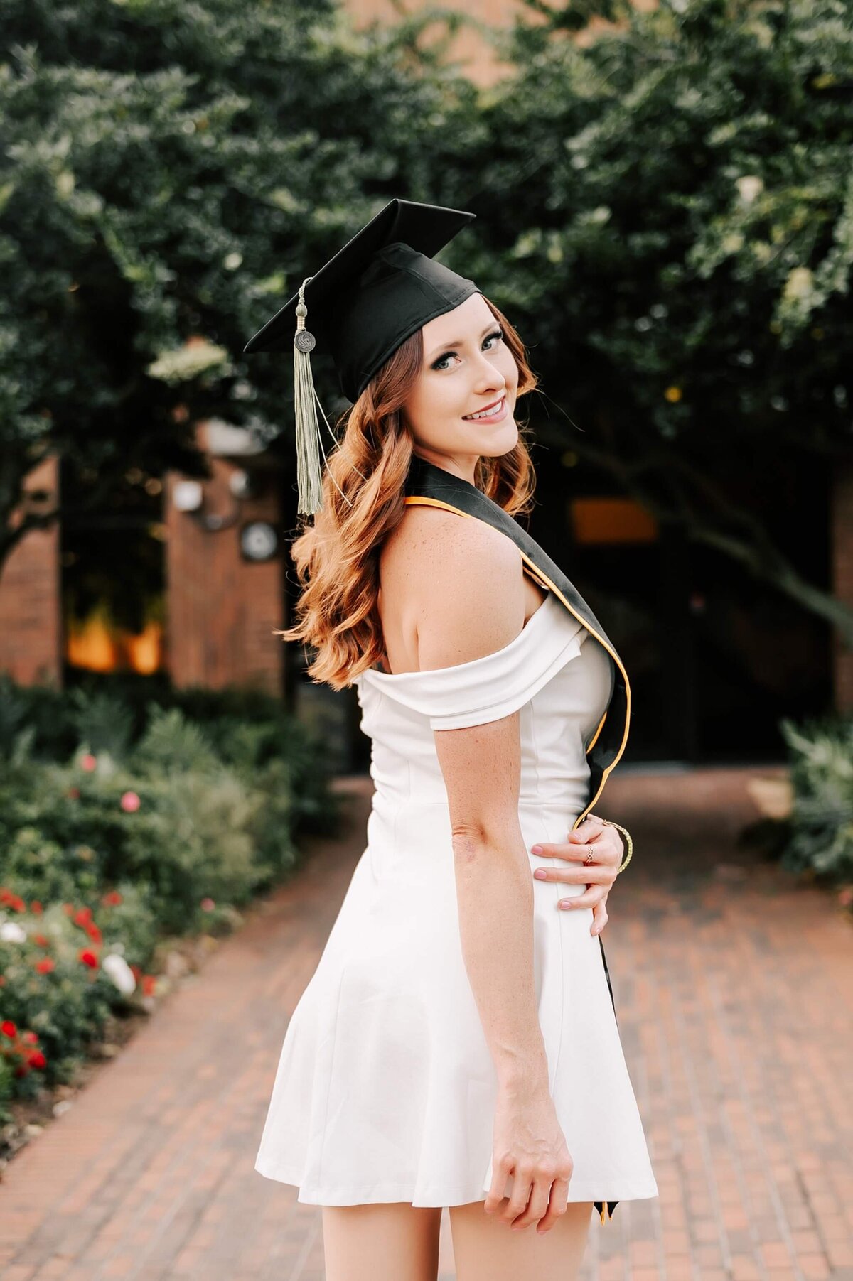 Graduate in her cap looking over her shoulder on the Orlando UCF Campus