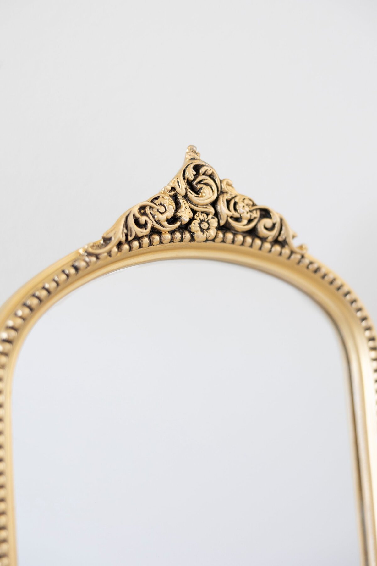 5x7 and 8x10 gold mirrors with ornate decor on the top