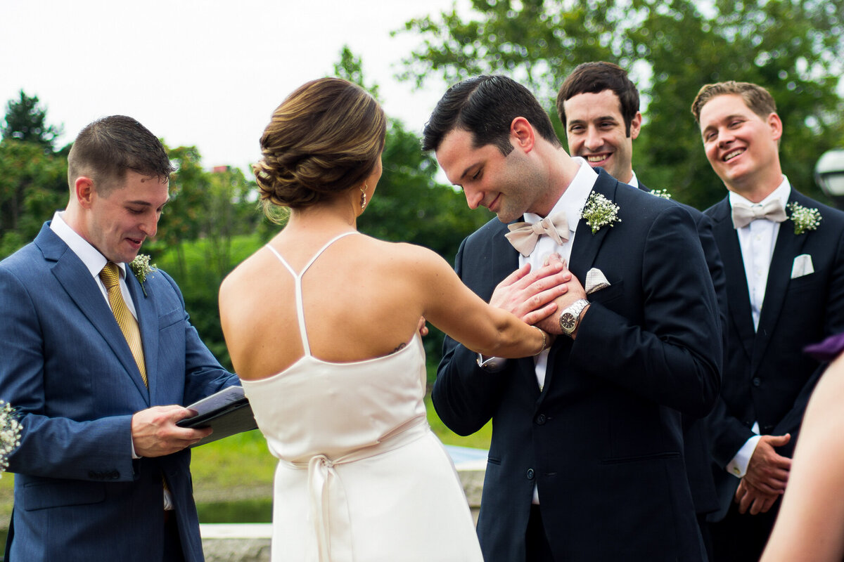Bride reads vows to her groom during outdoor ceremony in Columbus, Ohio