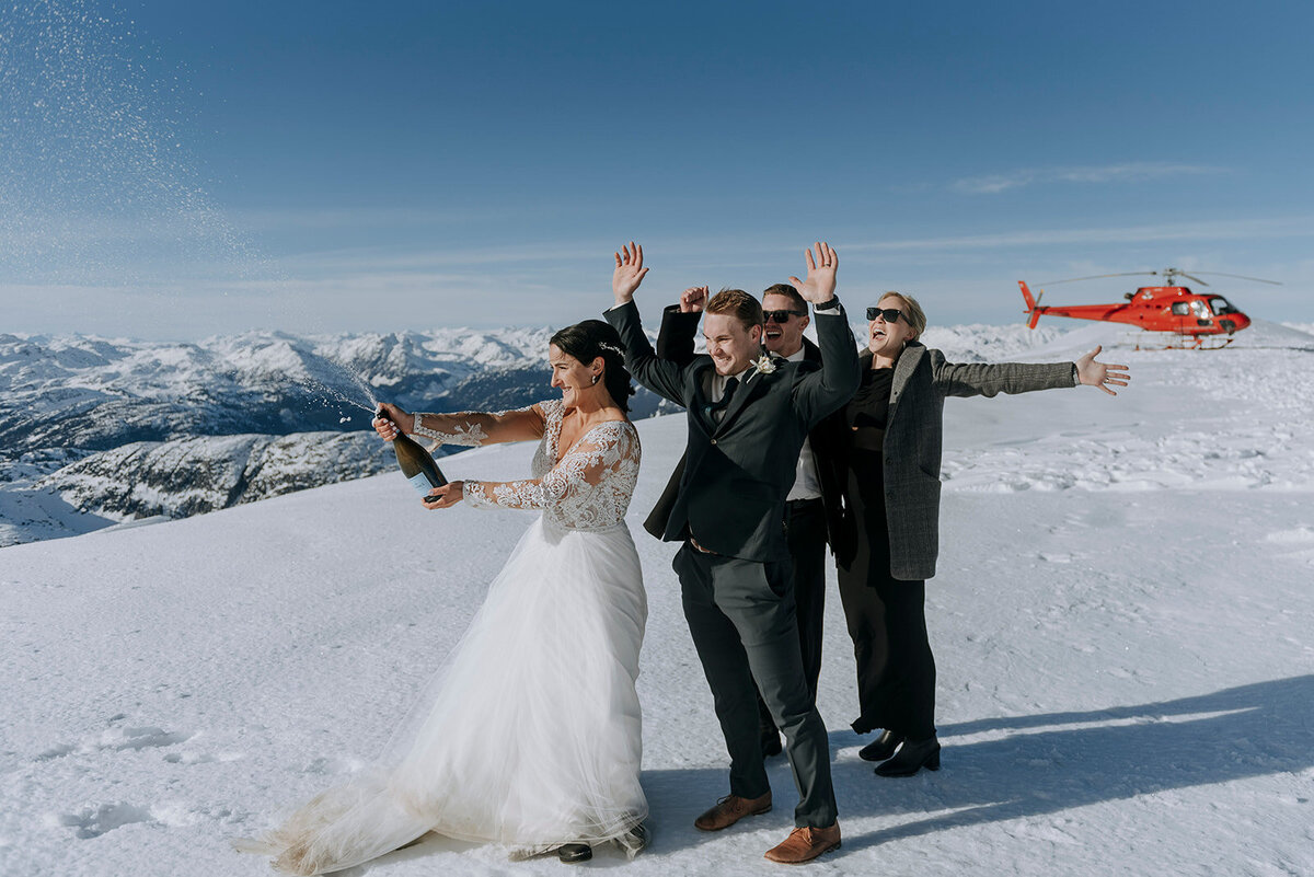 Whistler groom bends down to pet dog after Whistler wedding ceremony