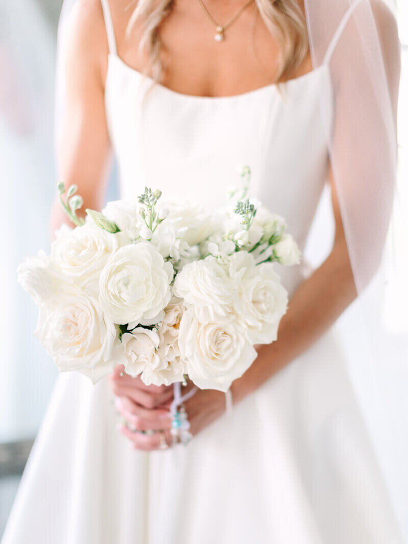 Bride holding bouquet at wedding by luxury wedding planner chicago