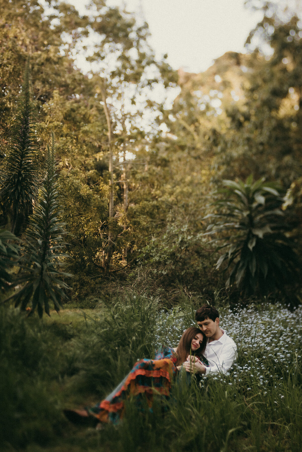 Bay Area elopement session in Golden Gate Park.  Couple cuddles while laying in a wildflower field.