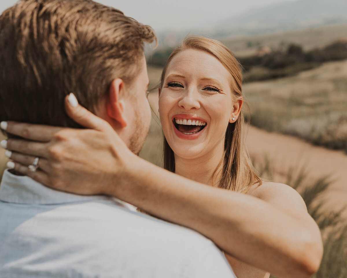 GIrl laughing in engagement photo
