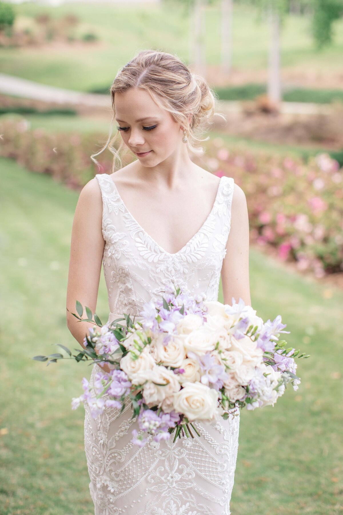 bride holding bouquet with lavender snapdragons by Austin wedding photographer Firefly Photography