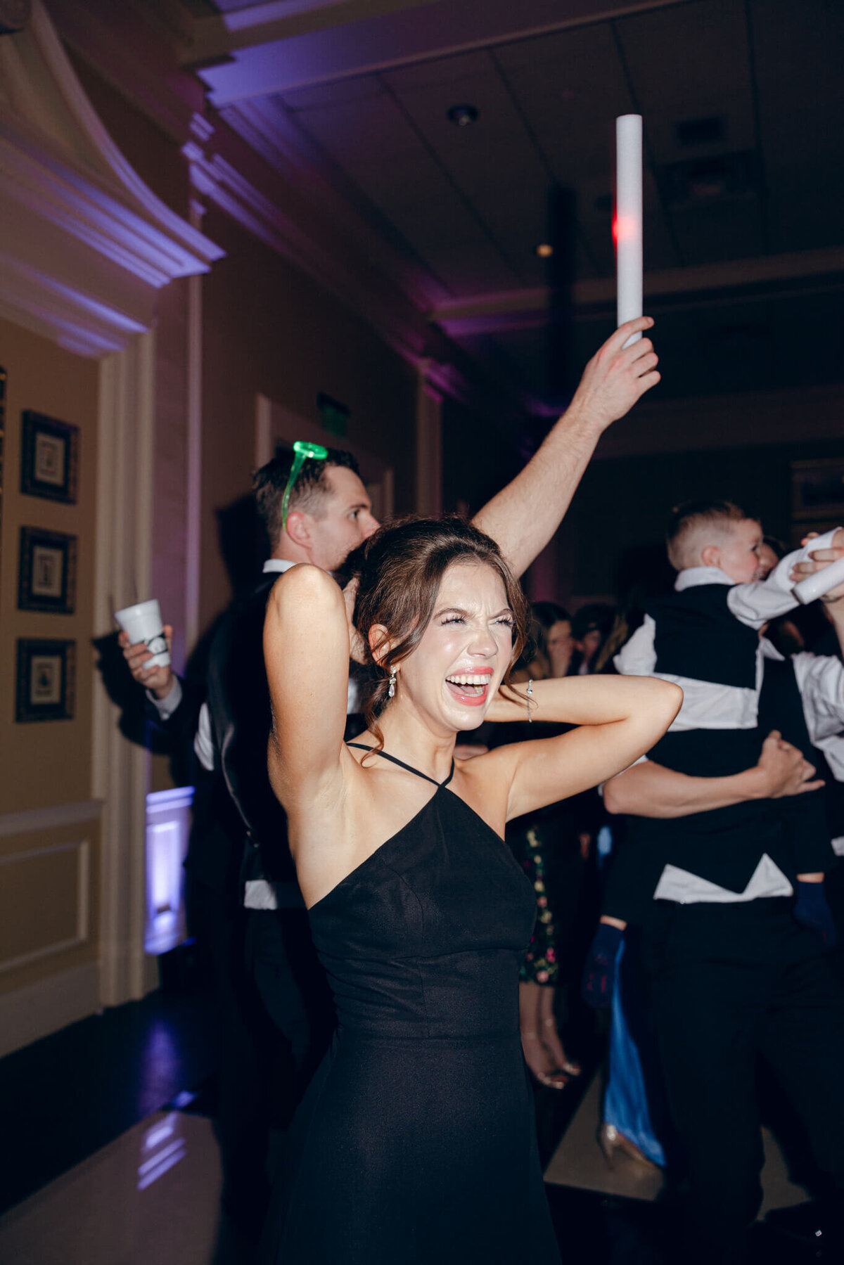 A wedding photo of guests dancing during the wedding reception