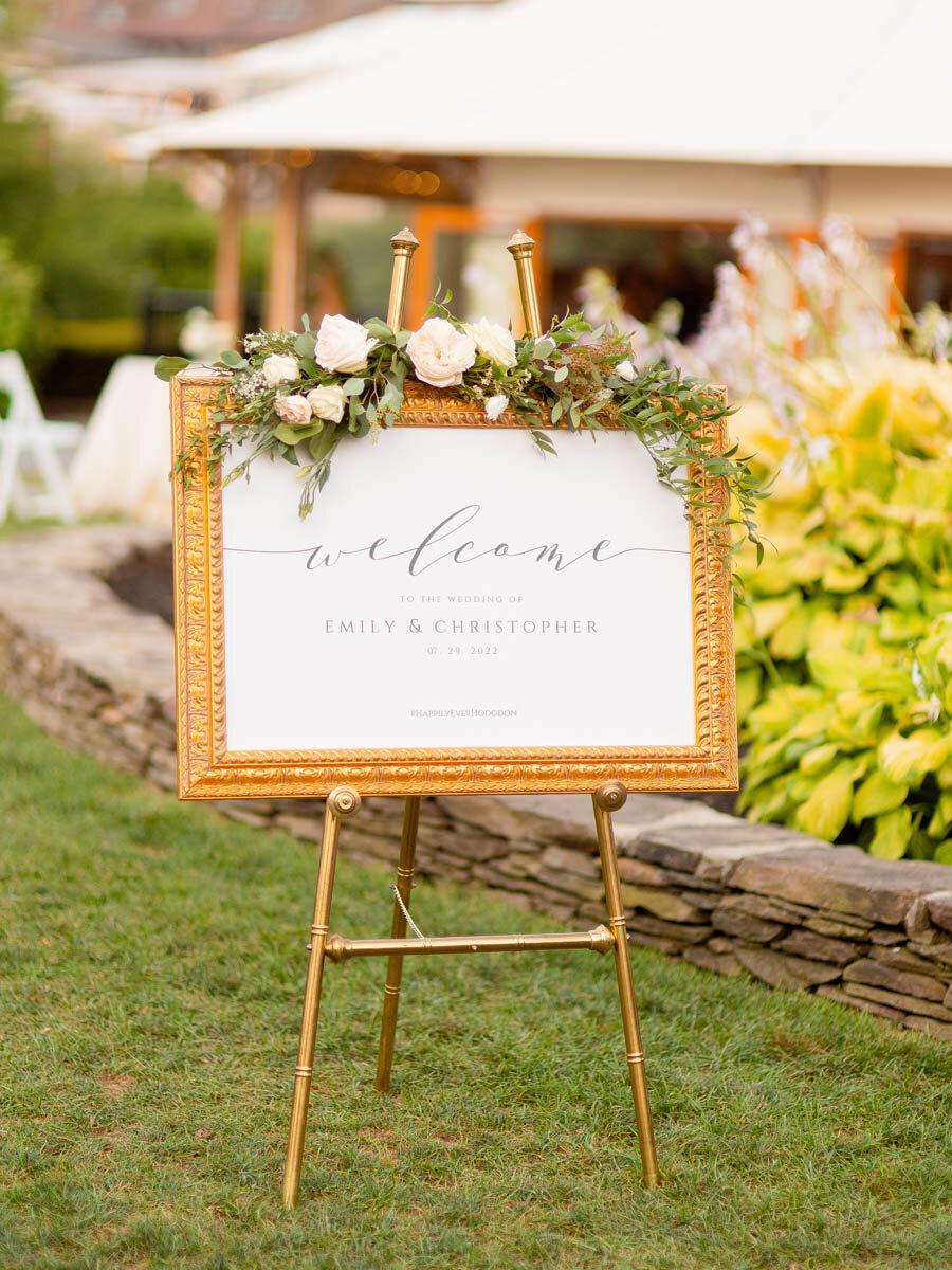 Mirror and floral wedding welcome sign.