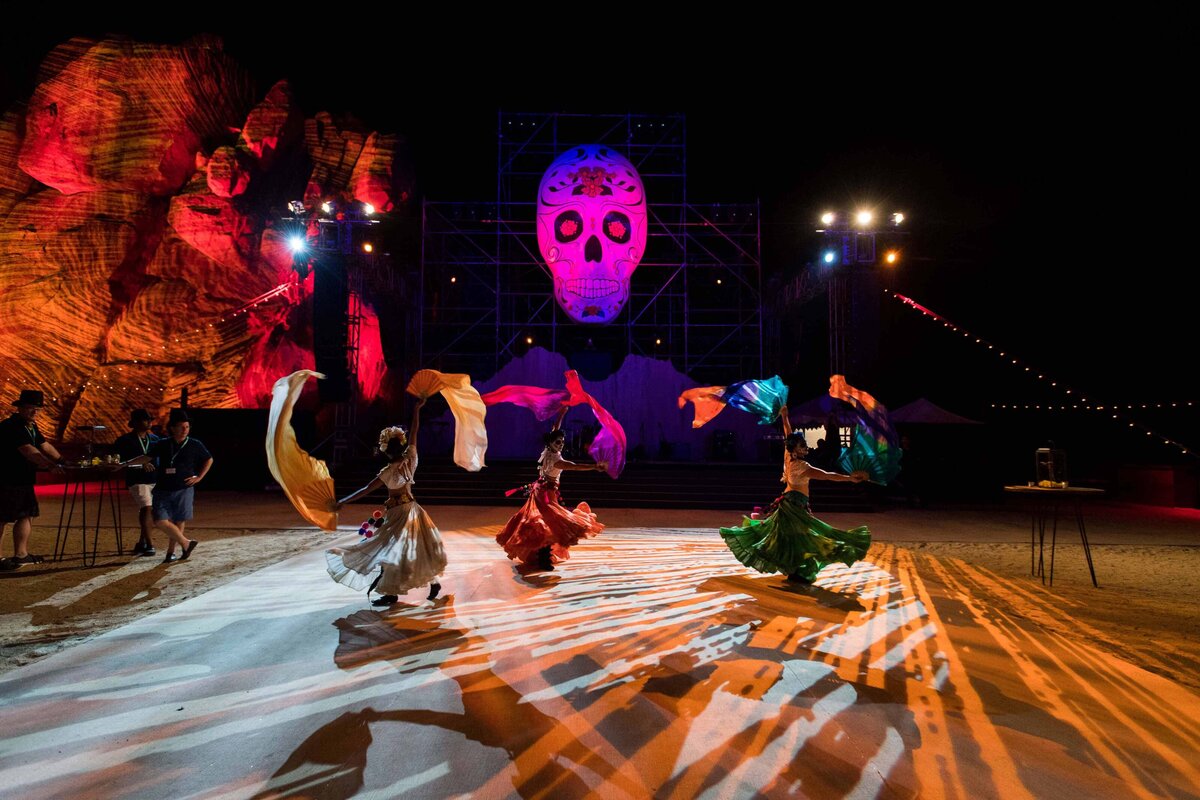 Dancers with silks and day of the dead costumes perform at incentive travel event in Cabo