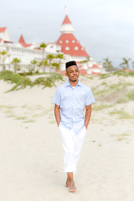 senior-boy-walking-on-coronado-beach