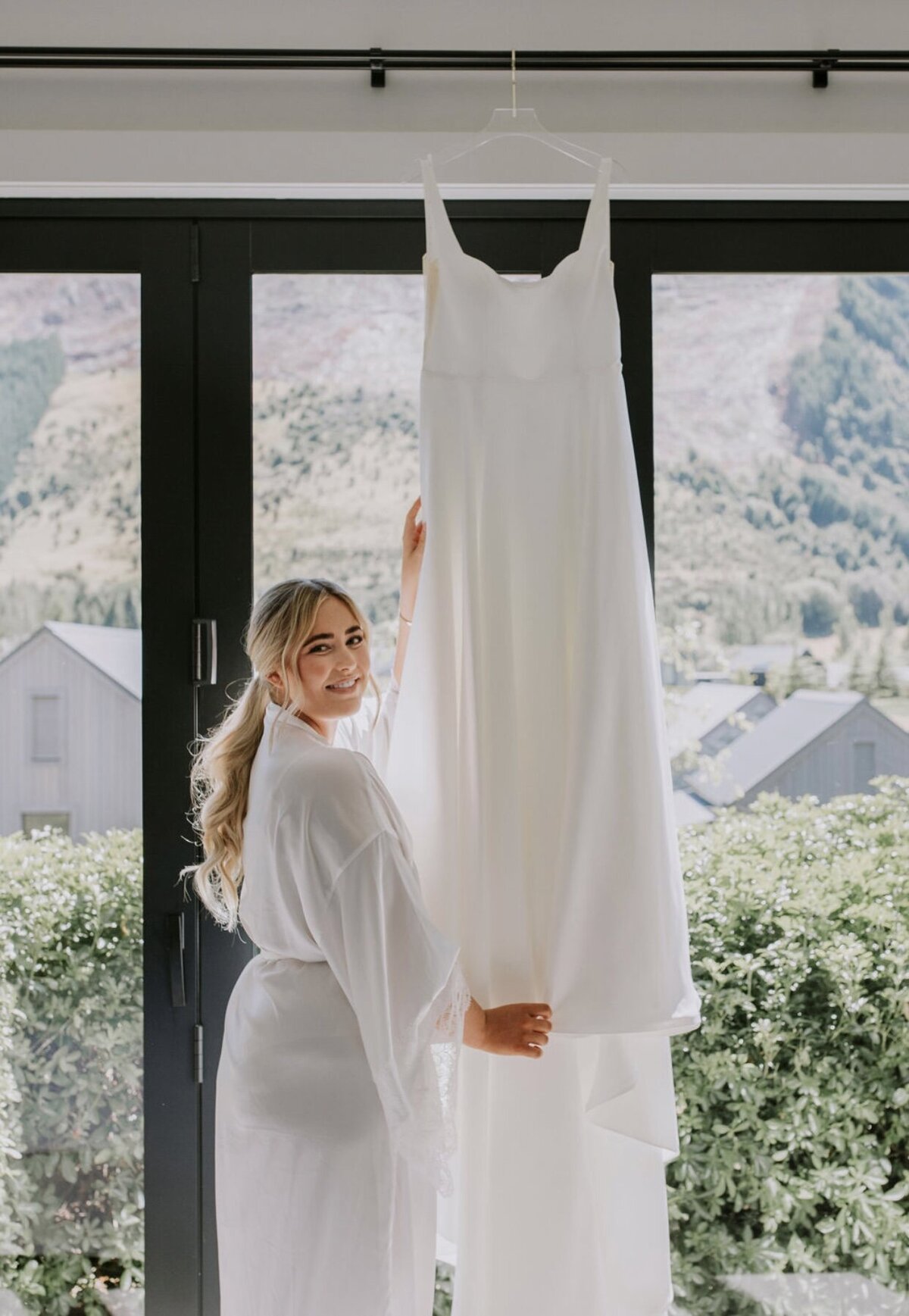 bride-holding-wedding-dress-smiling