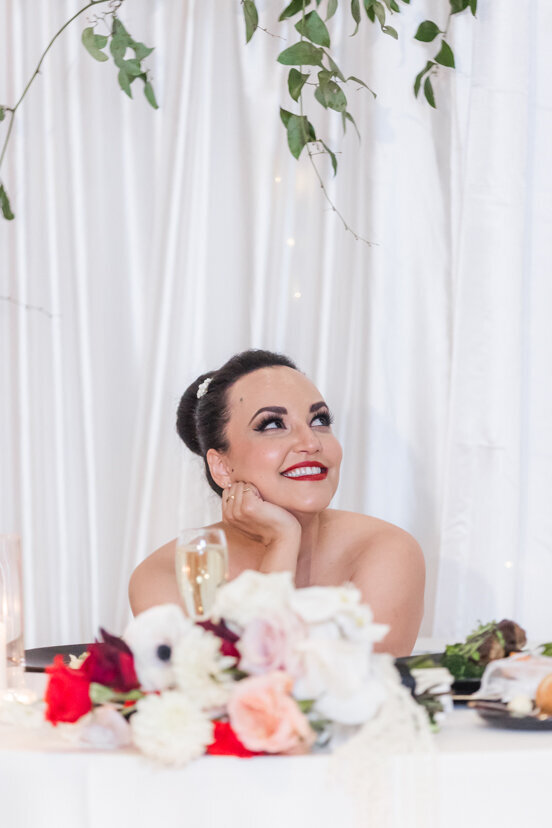 bride-sitting-at-sweetheart-table