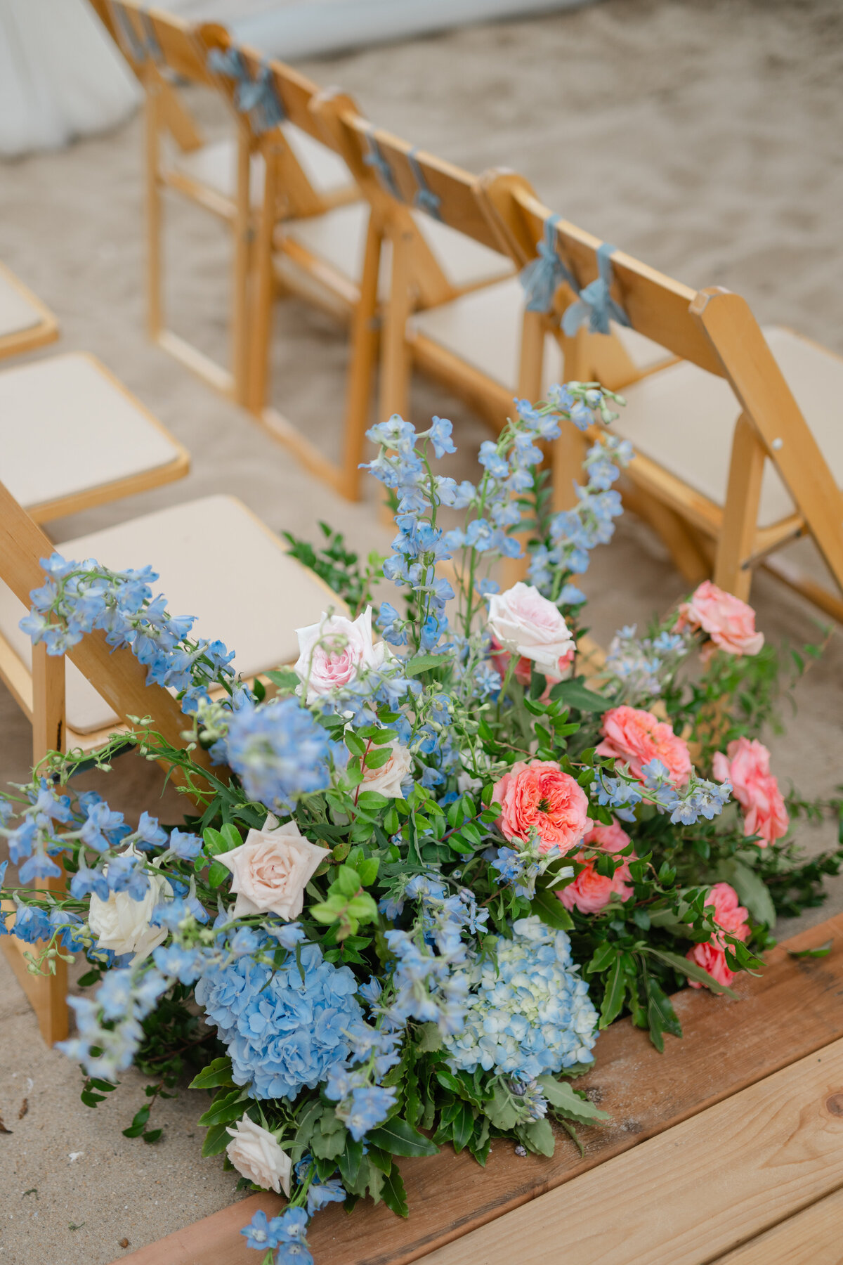 flowers-lining-the-aisle-to-accent-the-arbor