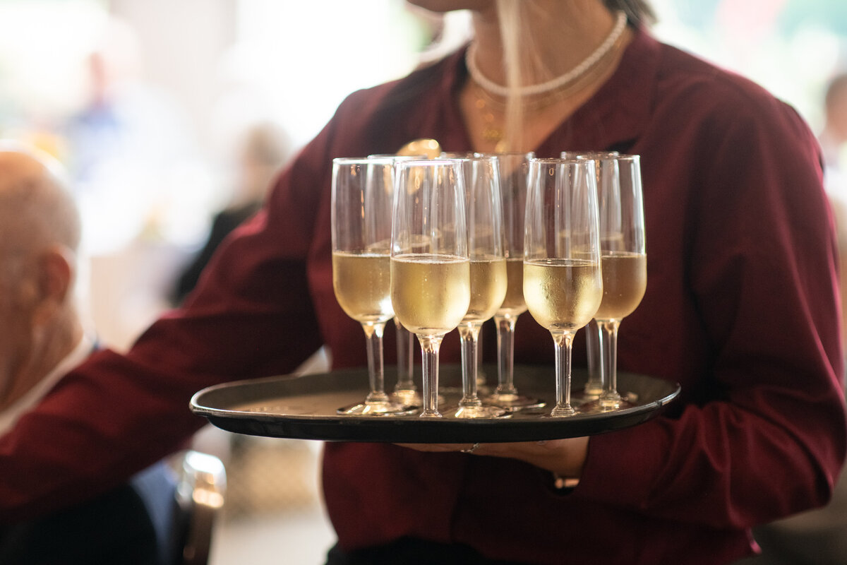 champagne flutes on a tray at  a party