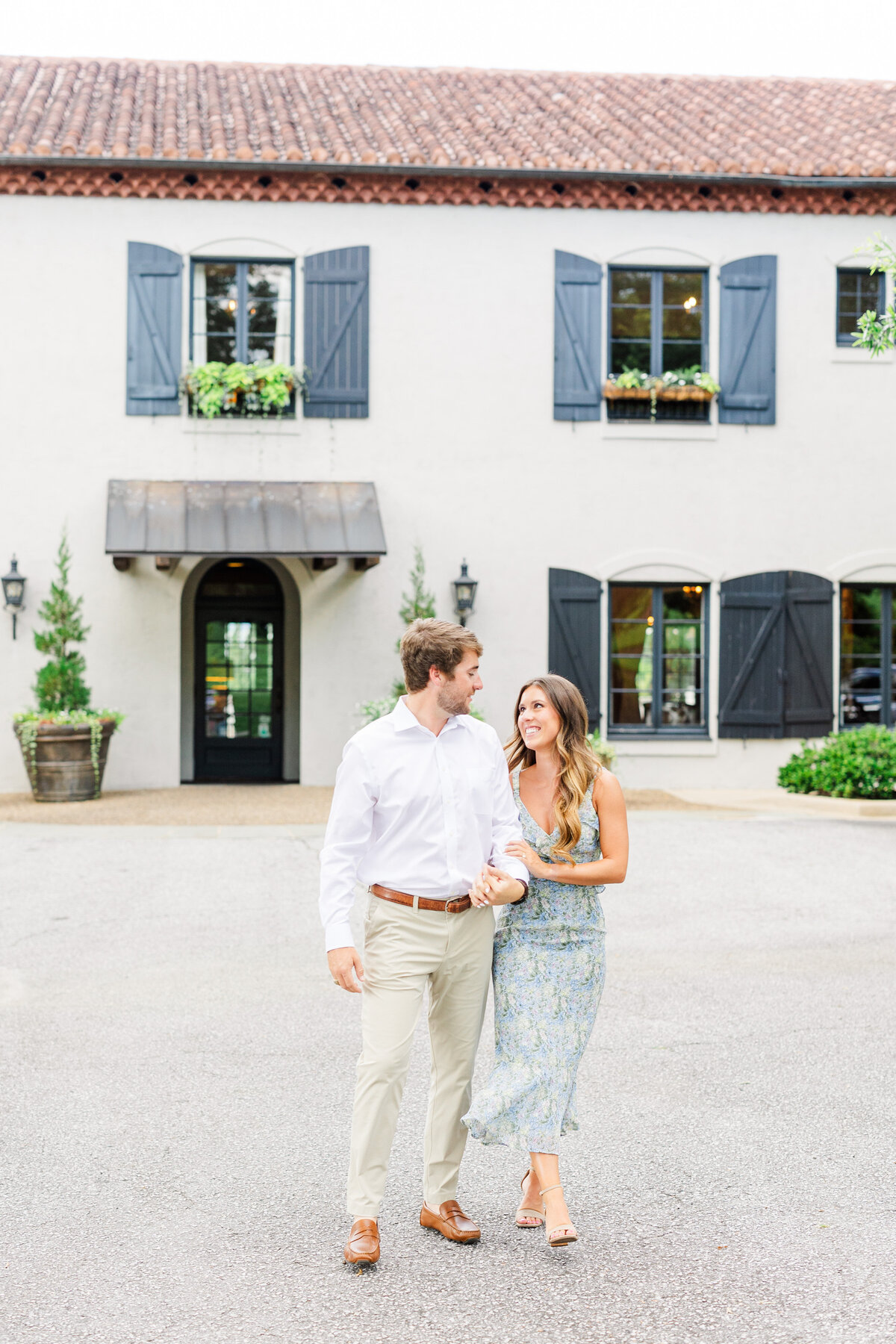 couple laughing during engagement session at hotel domestique