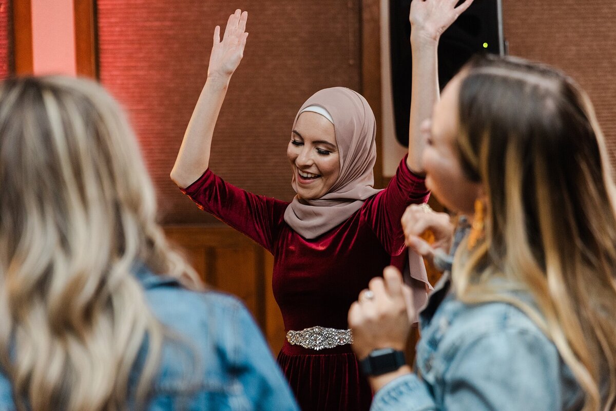 Multiple wedding guests dancing and celebrating during a wedding reception at the YMCA of the Rockies in Estes Park, Colorado.