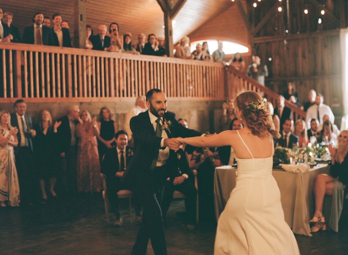 bride and groom dancing in a warm cozy space