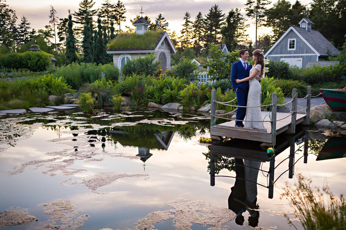 The couple stands at Maine Botanical Gardens in Boothbay Harbor Maine after their wedding ceremony