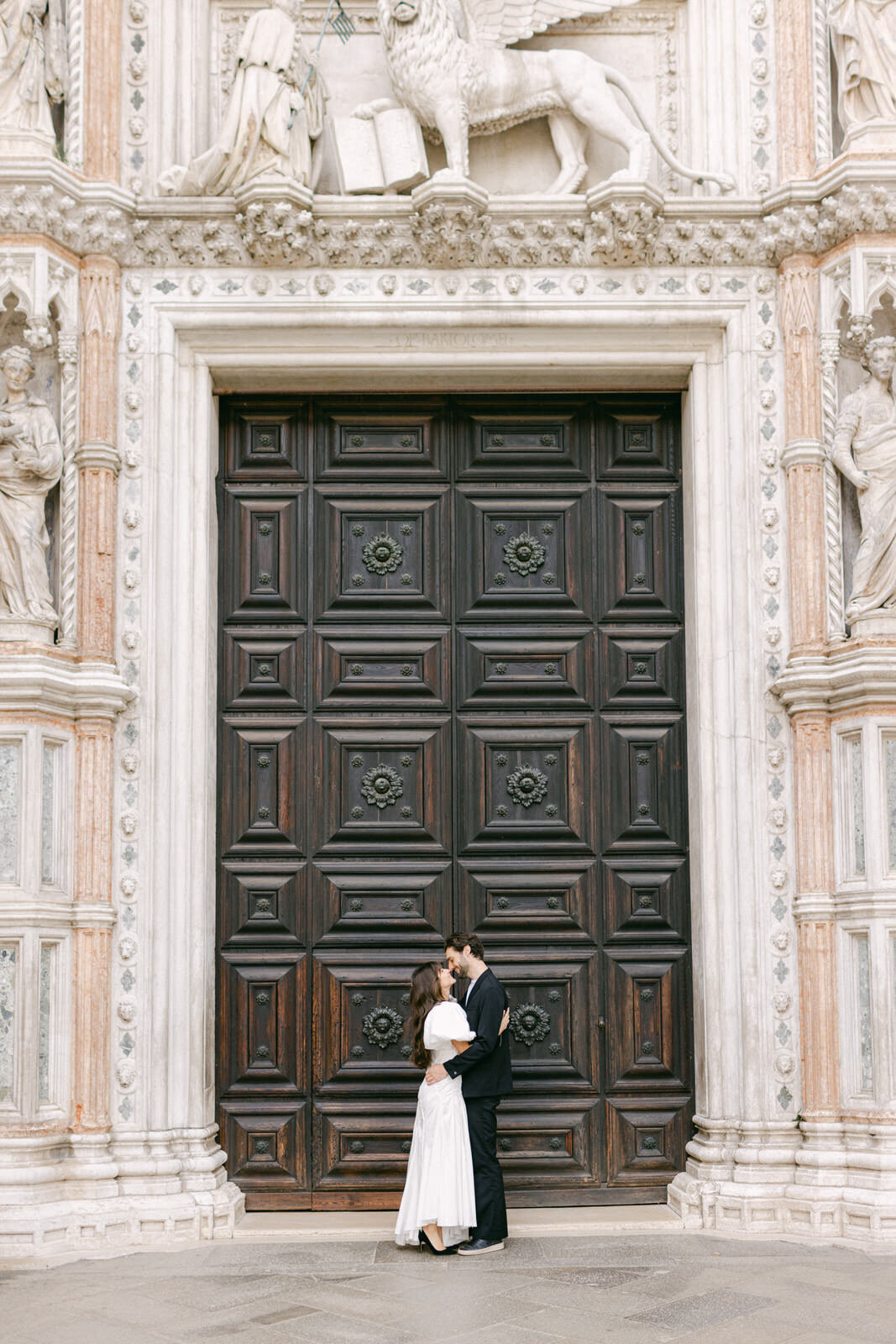 engaged couple in front of Basilica San Marco