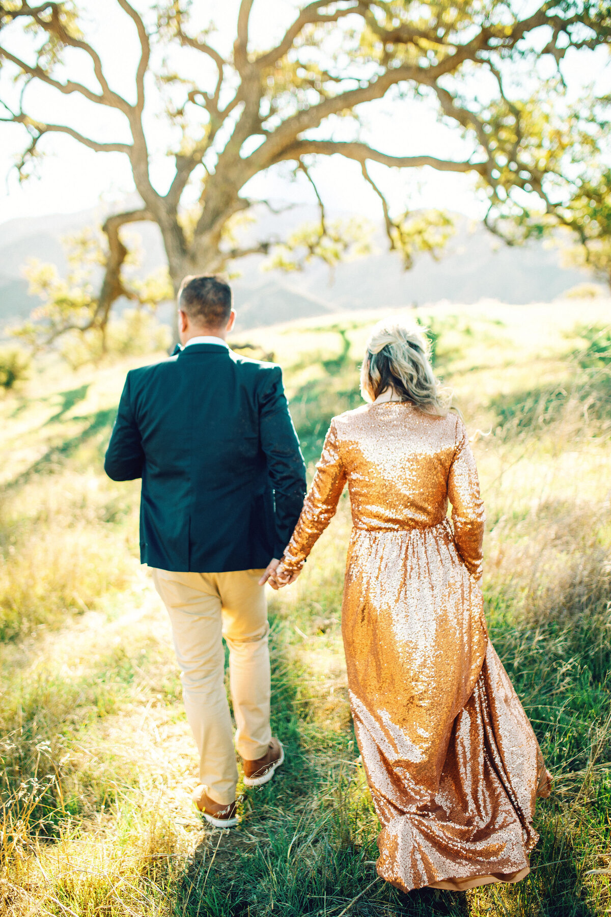 Family Portrait Photo Of Couple Holding Hands While Walking In The Meadow Los Angeles