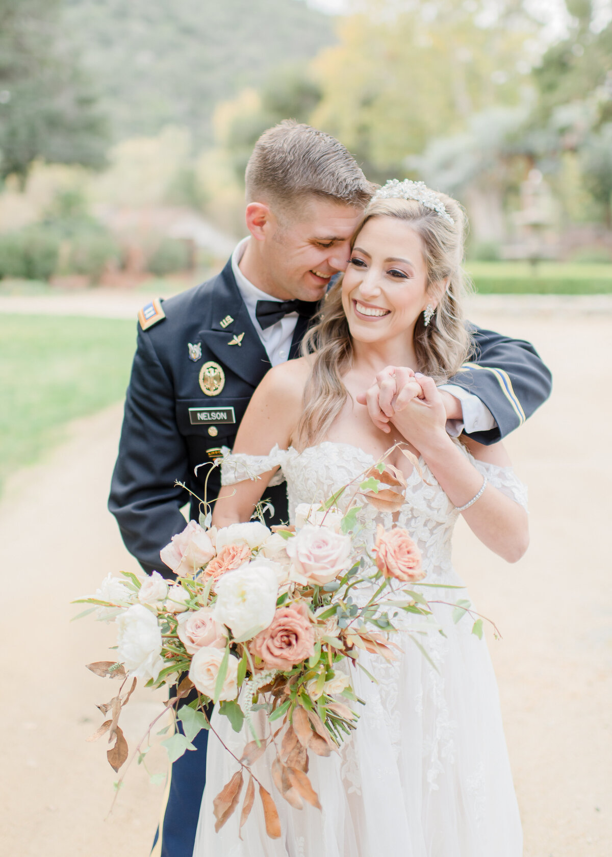 groom snuggling with her bride at their wedding.