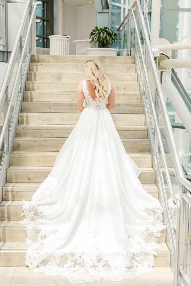 bride standing on staircase in wedding dress