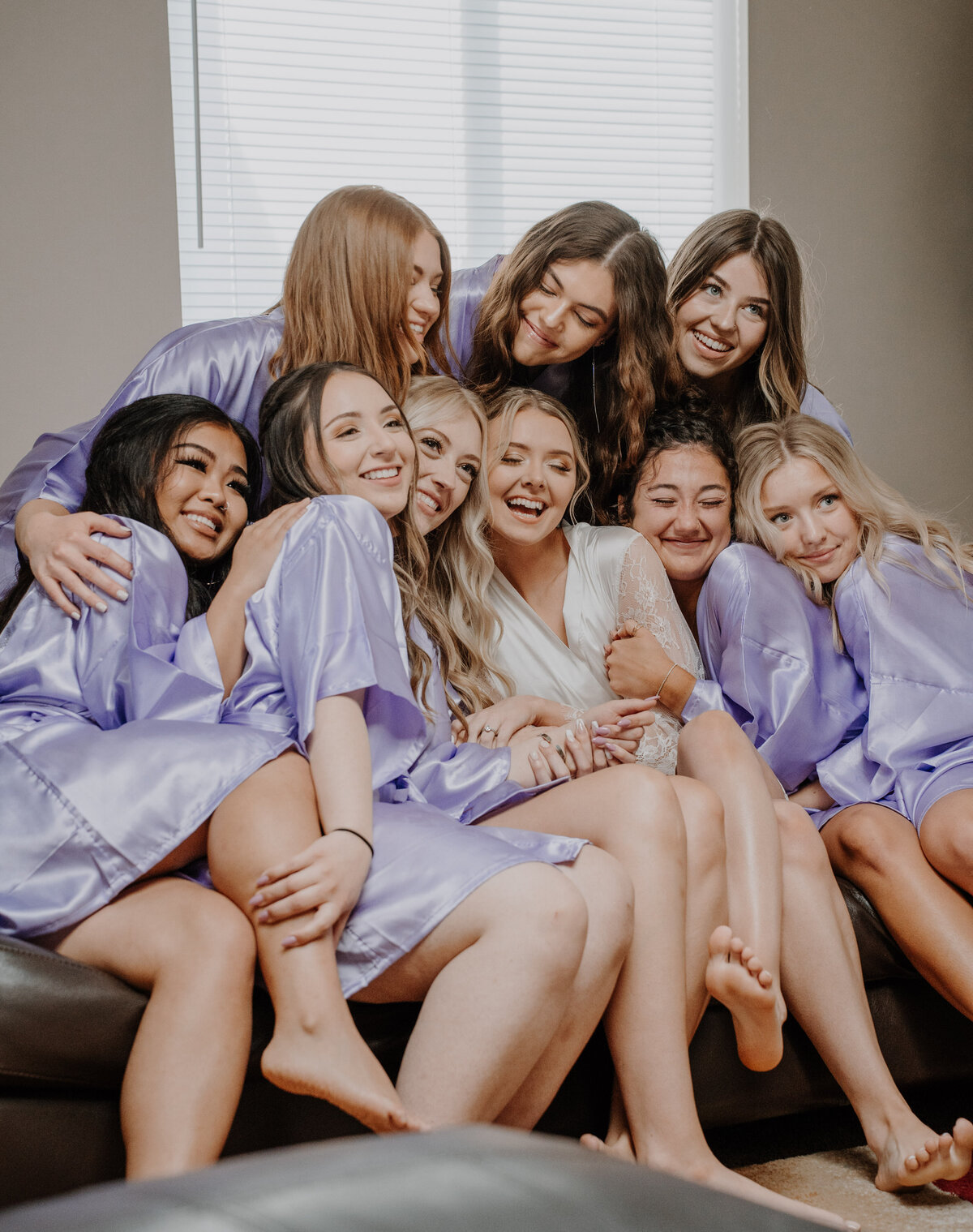 Group of girls in purple robes hugging