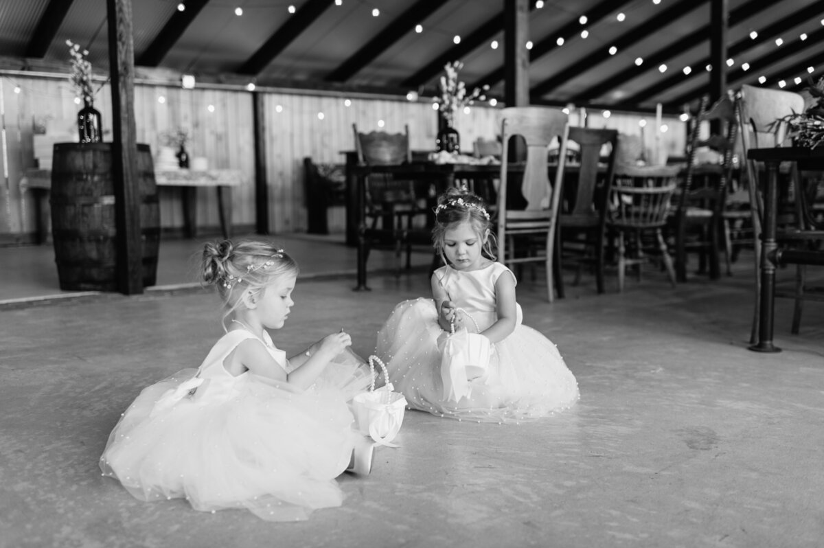 Flower girls dancing at wedding reception black and white