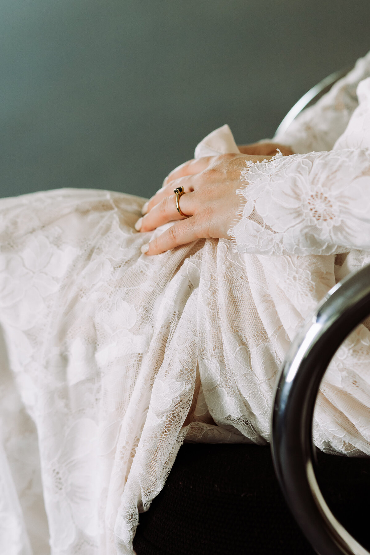 bride sitting in chair, getting ready for wedding